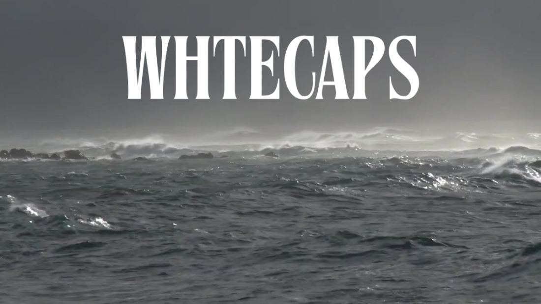 Stormy ocean with large waves and the word 'WHTECAPS' displayed.